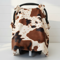 Cow Minky Western Carseat Tent against white shiplap wall — soft cow print minky with brown cotton underside, handmade in the USA