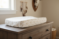 White with gold arrow changing pad cover on dresser in western nursery - lifestyle photo
